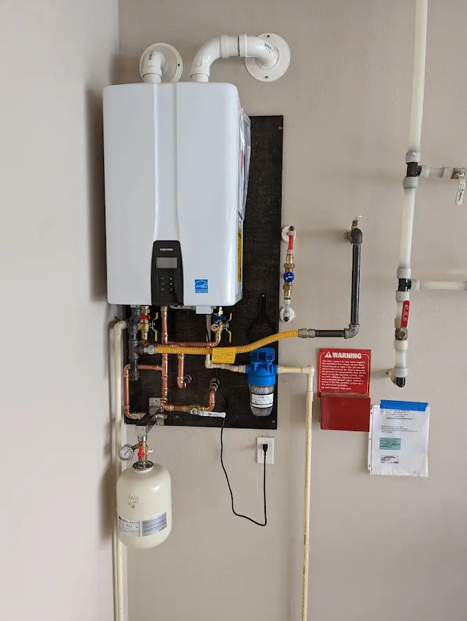 Professional plumber installing copper piping in a Atwater home